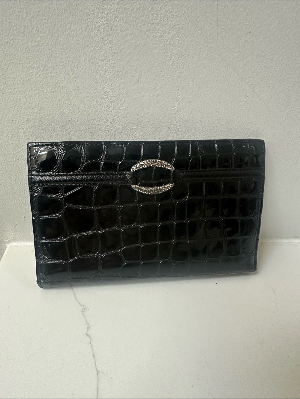 Black Croc-Embossed Patent Leather women’s wallet/Clutch with Silver Accent.
